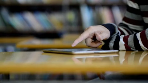 Hands using  tablet computer in library Stock Footage 88731335