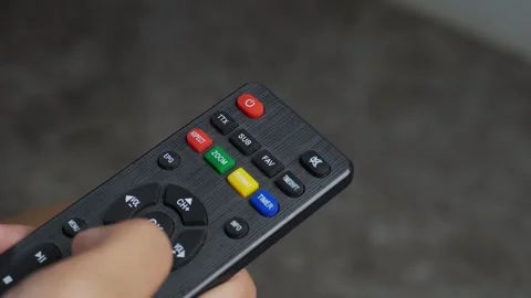 Hands using tv remote on floor background Stock Footage 276716801