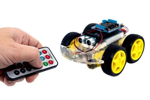Hands using a wireless remote turn on a programmable 写真素材