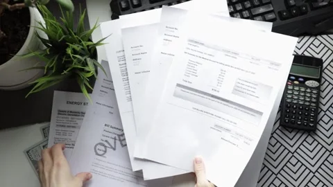 Hands with utility bills top view, water and heat service charges, home bud.. Stock Footage 301285653