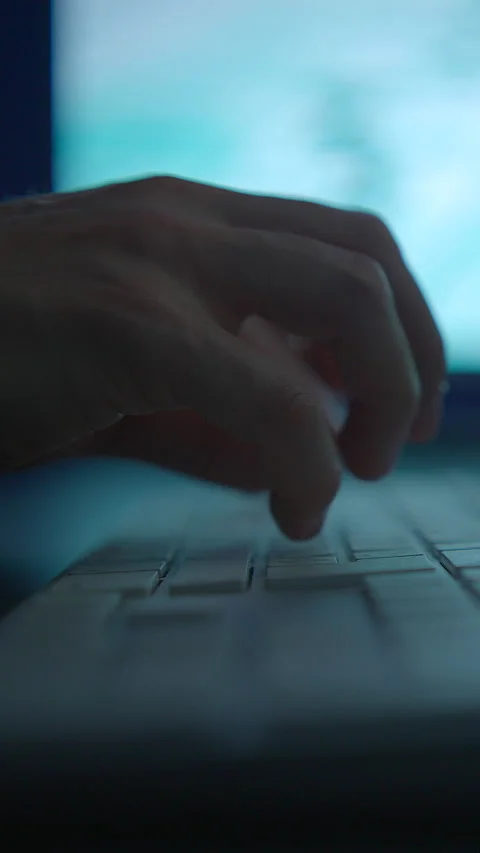 Hands Utilizing a Keyboard with a Computer Screen in the Background for Stock Footage 295228319