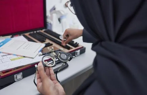 Hands, vision and optometry with an islamic woman at work in eyecare for Stock Photos