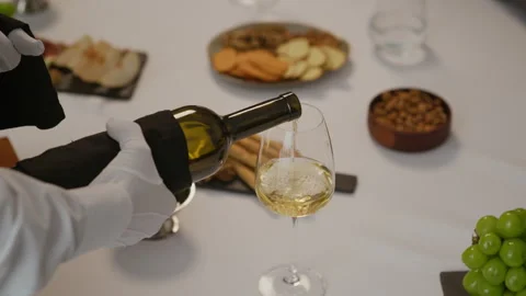 Hands of Waiter Serving White Wine at Fancy Dinner in Restaurant Stock Footage 321403451