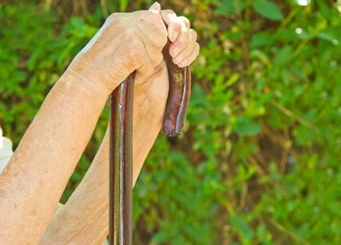 Hands on walking stick Stock Photos