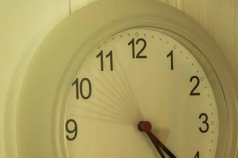 Hands on a wall clock Stock Photos