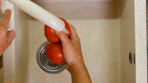 Hands wash tomatoes Stock Footage 113196056