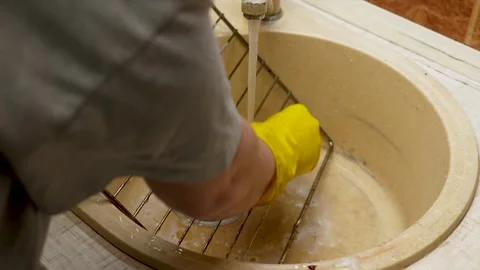 Hands washing the baking tray with a sponge close up Video stock 267864389