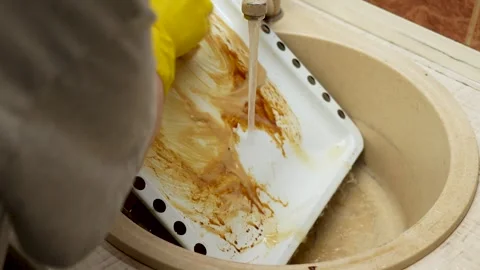 Hands washing the baking tray with a sponge close up Stock Footage 267864448