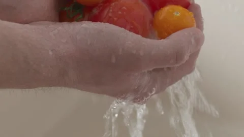 Hands washing tomatoes under running water in the white sink. Healthy eating Video stock 145067726