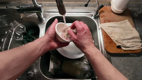 Hands Washing White Ceramic Cup Under Running Water in Stainless Steel Kitc.. Video stock 306575476