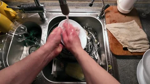 Hands Washing White Ceramic Plate Under Running Water in Stainless Steel Ki.. Stock Footage 305654802