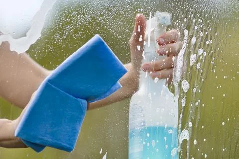 Hands washing window of car Stock Photos