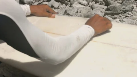 Hands waxing surfboard Stock Footage 72569189