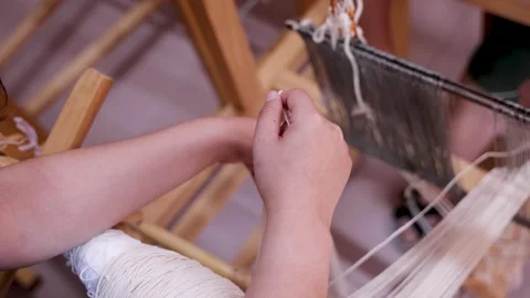 Hands Weaving Threads on Traditional Albanian Loom Stock Footage 337959837