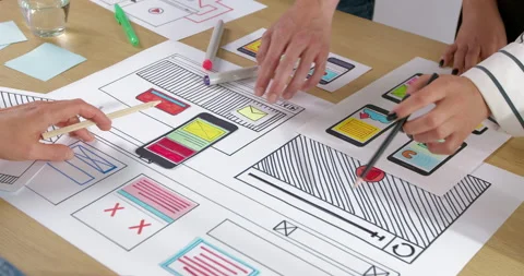 Hands of web designers creating sketches of applications for smartphones.  Stock Footage 210223180
