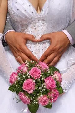 Hands on wedding bouquet Stock Photos