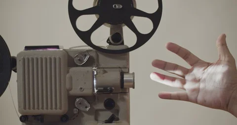 Hands were waving the light projector 8 mm film retro playing. Stock Footage 109200055