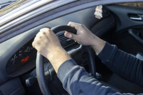 Hands at the wheel of a car Stock Photos