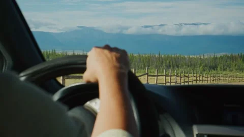 Hands on wheel, driving through mountain countryside 스톡 동영상 346385534