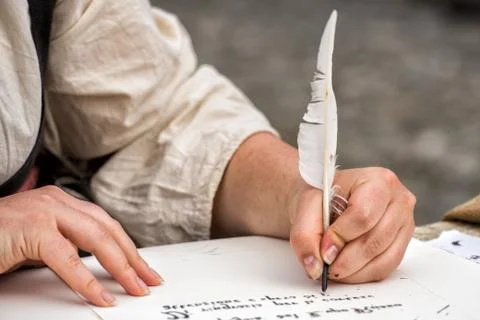 Hands while writing a letter with a plume Stock Photos