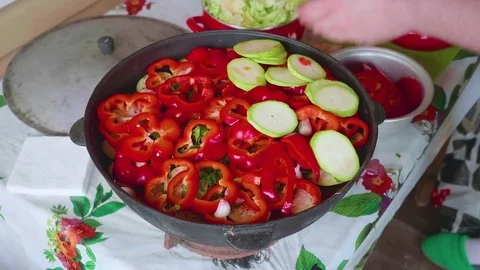 Hands of white cook add marrow into large cooking pot with vegitables. Stock Footage 76370175