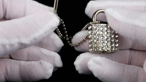 Hands in white cotton gloves performing a detailed inspection of jewelry.  Stock Footage 331333686