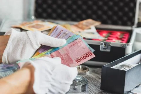 Hands in the white gloves hold different banknotes Stock-Fotos