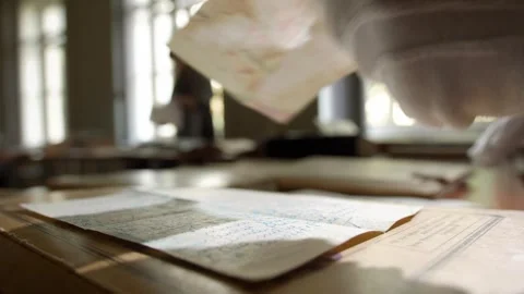Hands in white gloves leaf through old paper documents on the table Stock Footage 243721169