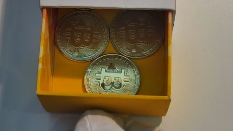 Hands in white gloves opens box with bitcoins Stock Footage 98263844