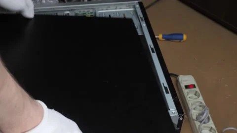 Hands in white gloves put the side door on the PC case lying on its side Stock Footage 131094939