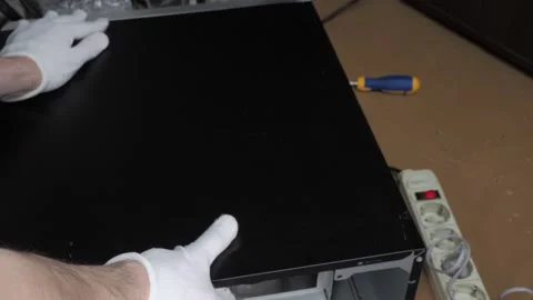 Hands in white gloves remove the cover from the PC case Stock Footage 131094967
