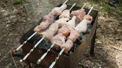 Hands in white gloves roll chicken barbeque on skewers on mangal. Up view. Stock Footage 114370198