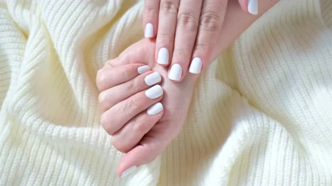 Hands with white manicure isolated on knitted background. Stock Footage 219522690