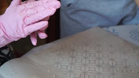 The hands of a white woman and a white child make cookies and lay on a sheet of Stock Footage