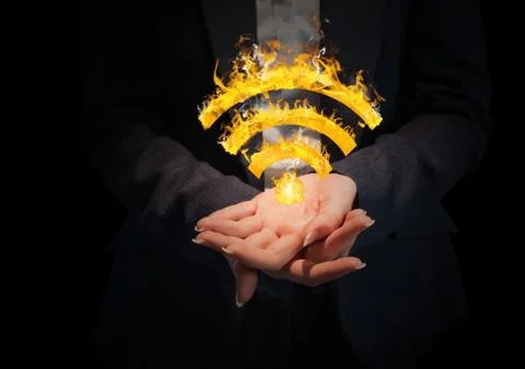 Hands with WIFI fire icon between. Black background Stock Photos