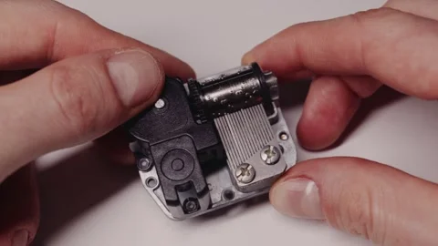Hands Wind Mechanical Music Box Playing Melody In Detailed Macro Shot Video stock 329921332