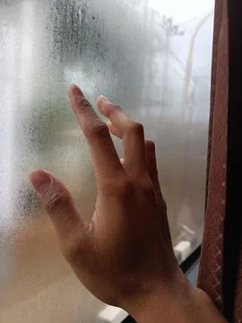 Hands to windows in rain Stock Photos