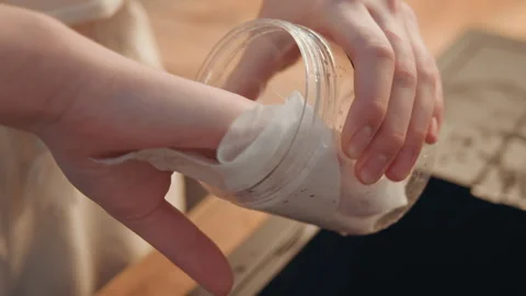Hands wiping glass jar interior removing water droplets for cooking storage Stock Footage 345537245