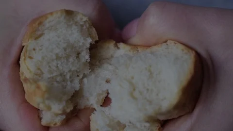 Hands of woman breaking baked bread in two parts Stock Footage 123785105
