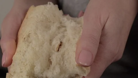 Hands of woman breaking baked bread in half Stock Footage 123789330