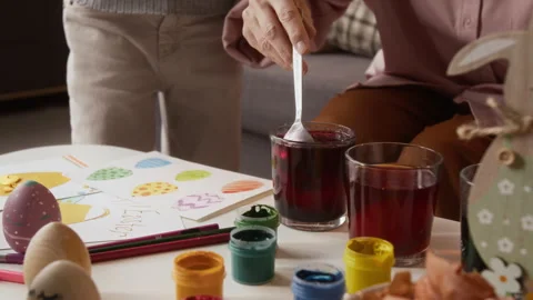 Hands of Woman Dying Easter Eggs with Children Stock-Footage 327889281