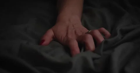 Hands of woman holding on blanket while lying on the bed orgasm sexuality Stock Footage 190890153