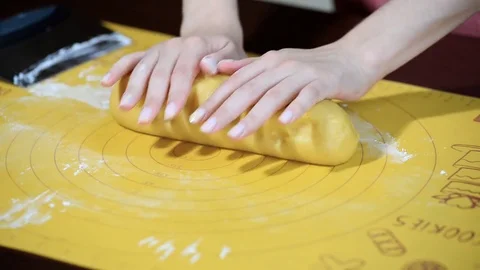 Hands woman kneads dough to cook a pie and divide it to pieces Stock Footage