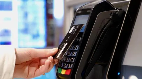 Hands of a woman making a payment using a credit card terminal, 写真素材