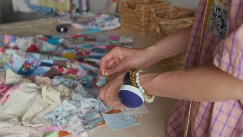 Hands of Woman Pinning Patchwork Squares for Sewing Quilt Stock Footage 315759928
