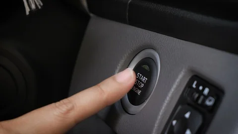 Hands of woman pushing engine start button Stock Footage 98328841