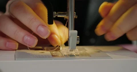 Hands of woman put pink thread into tiny needle hole Stock Footage 207455148
