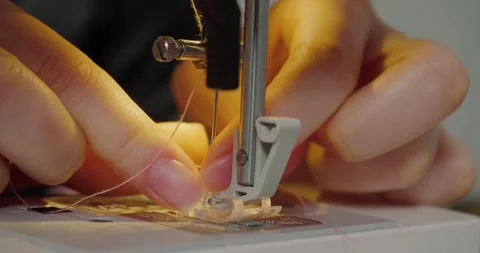Hands of woman put pink thread into tiny needle hole Stock Footage 211559063