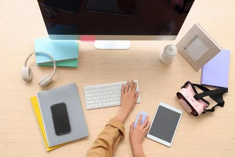 Hands of woman using computer mouse and keyboard at table in office, top view Stock Photos