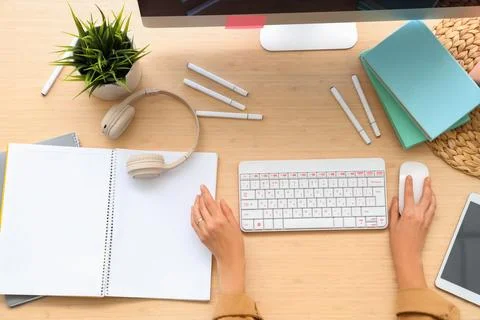 Hands of woman using computer mouse at table in office, top view Stock Photos